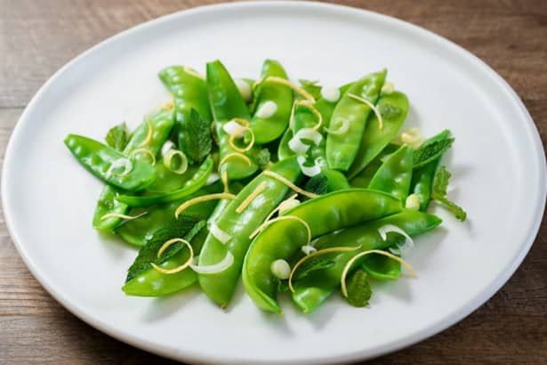 Snow peas with spring onion mint and lemon zest