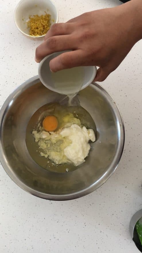 Add egg, lemon zest, lemon juice, olive oil and yogurt