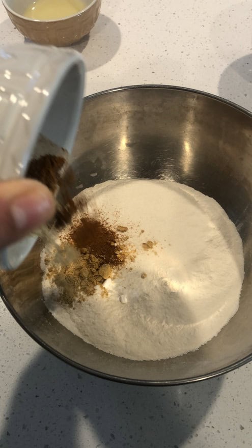 In a separate bowl combine flour, baking powder, baking soda, salt and all the spices.