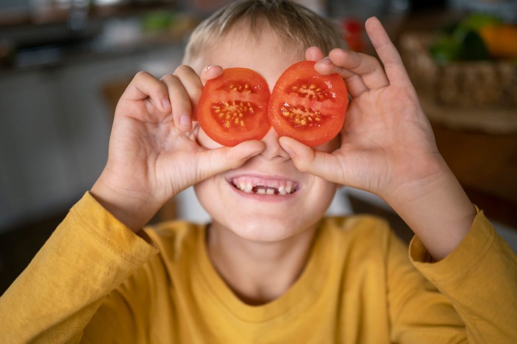 Boy with tomatoes