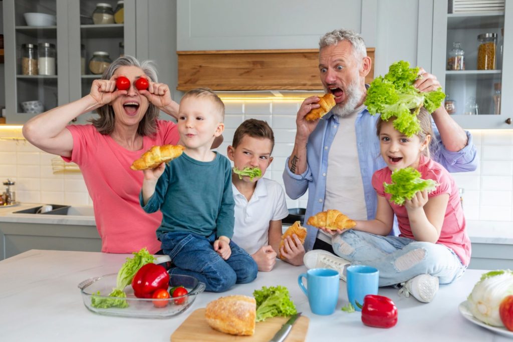 Family in kitchen preparing food